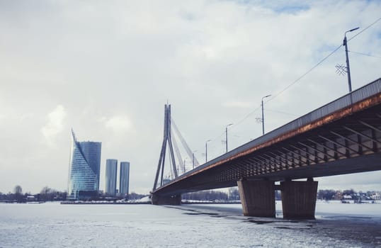 Bridge across the winter Daugava river in Riga, Latvia