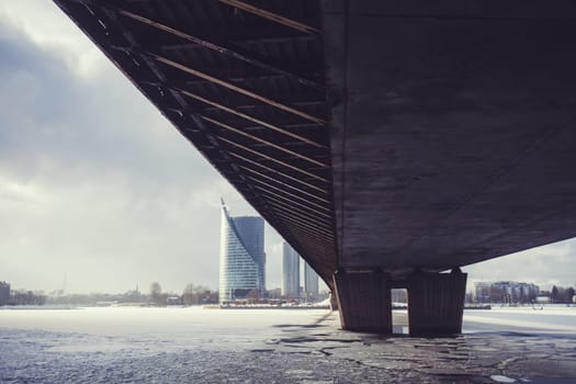 under bridge over river Daugava in winter day