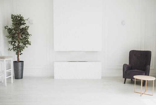 white minimalistic interior of the living room with a fireplace