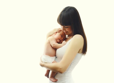 Happy young mother holding cute infant, baby sleeping in arms on white studio background