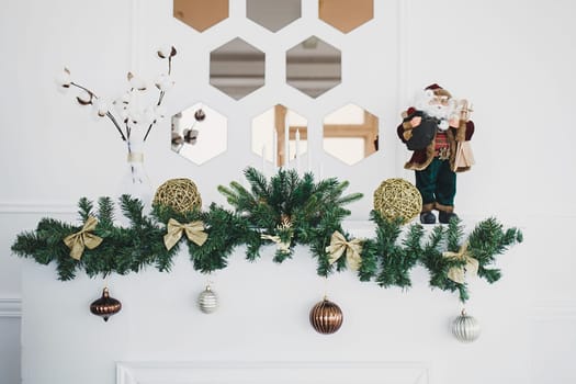 Decorated for christmas fireplace with christmas tree and toy Santa