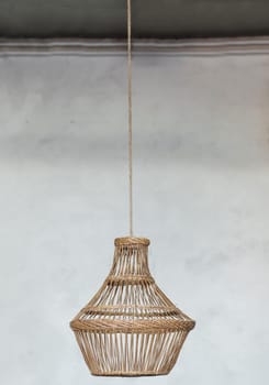 Vintage straw lamp hanging on the ceiling in the room