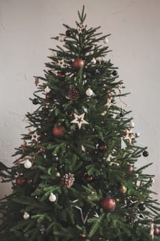 green christmas tree with decorations in the room