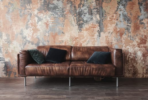 leather sofa with pillows in the loft interior
