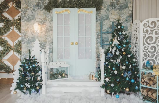Porch with door in Christmas decorations and Christmas trees. Spruce garlands around the door. 