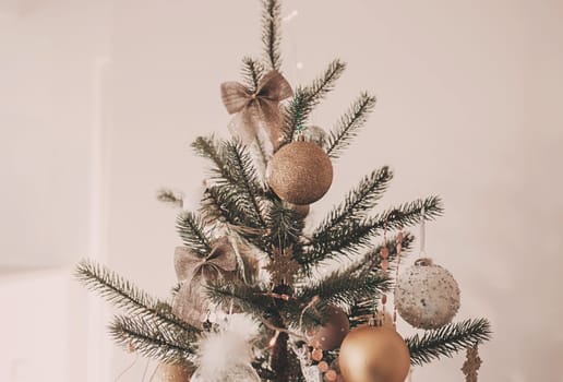Beautiful green christmas tree decorated with balls and garlands. Close-up photo