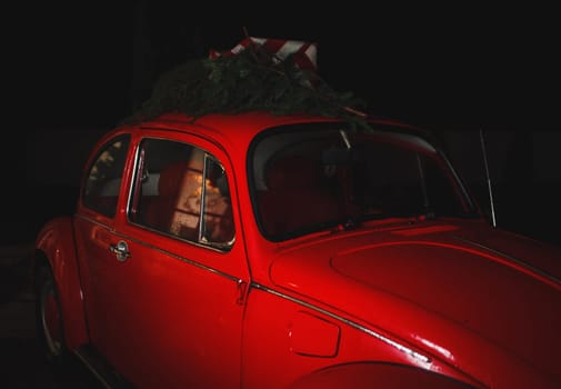 Christmas concept - red retro car with gifts