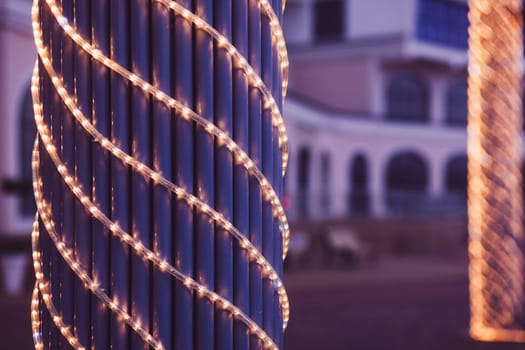 Christmas illumination in the city, Golden bokeh lights on the city street. Christmas street decor