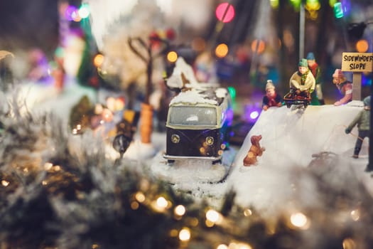 miniature image of Christmas scene-retro bus and people with sleds