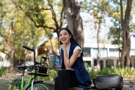 Businesswoman ride bicycle sit outside working Entrepreneur commuting by cycling reduce carbon footprint. Bike to work eco friendly alternative vehicle green energy.