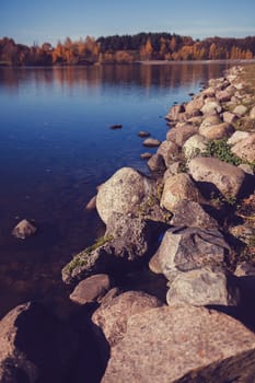 large stones lie on the background of a blue lake