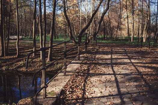 old stone bridge over the river in autumn Park