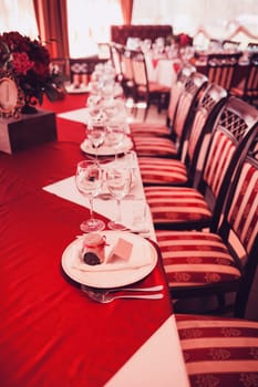 decorated wedding table with dishes and glasses serving