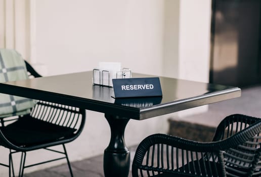 Reserved table sign in restaurant outdoors