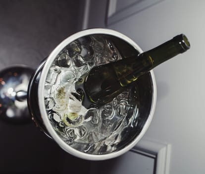 Bottle of champagne in bucket of ice in restaurant