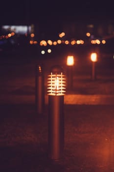 small city lantern glows on the lawn