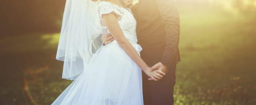 Young wedding couple enjoying romantic moments on meadow