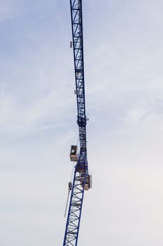 Part of a construction tower crane against the blue sky