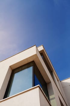 Modern apartment with a glass facade of the building. Detail of a new luxury home and residential complex