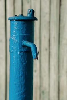 drinking column, blue water pump outdoors