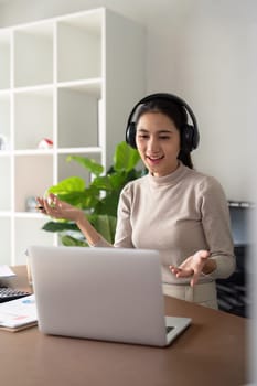 Woman asian on video call with work from home laptop, headphones and virtual international online meeting. webinar for remote working or global update in computer.