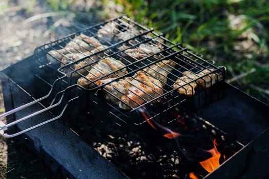 Roast chicken legs on grill outdoors
