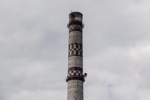 urban industrial pipe of a thermal power plant against the sky. environmental problem