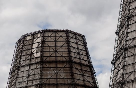 large industrial towers of a thermal power plant against the sky. environmental pollution