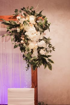 wedding arch decorated with flowers in the restaurant