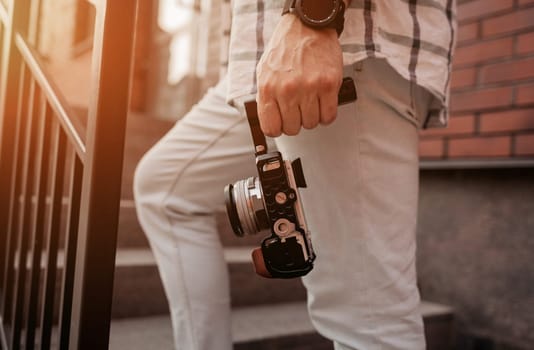 man holds a digital camera for shooting video content