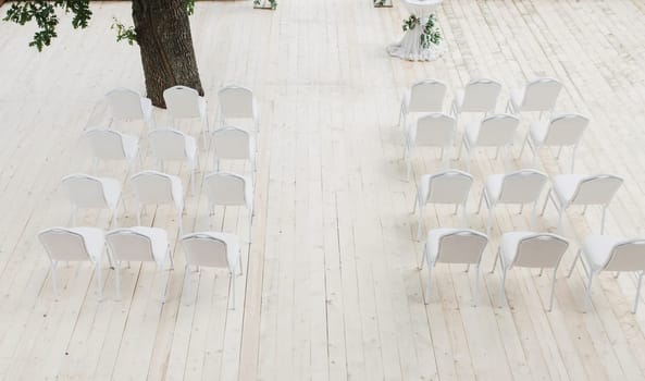 stylish white chairs. Luxury decor for the wedding ceremony.