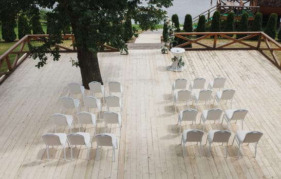 Amazing beautiful place for a wedding ceremony with a wedding arch, and empty white chairs