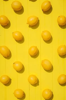 Many lemons on bright yellow background. Lemon fruit, citrus minimal concept, vitamin C. Creative summer concept