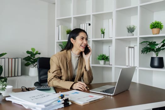 Businesswoman working with laptop at modern eco-friendly office surrounded by tree.