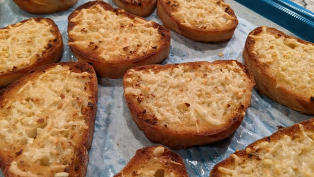 Freshly Baked Cheesy Garlic Bread on Blue Tray, Perfect Comfort Food for Home Cooking in Indiana, 2021