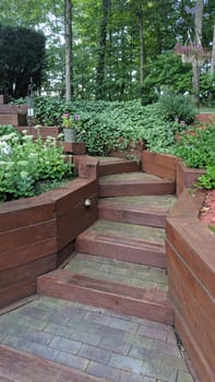 Serene garden scene featuring a winding wooden staircase nestled among vibrant greenery and colorful blossoms, an idyllic pathway to tranquility and outdoor living.