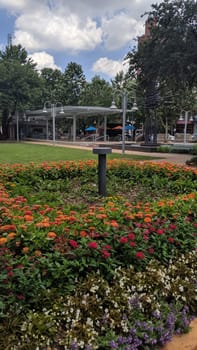 Sunny Urban Park with Colorful Flower Beds, Contemporary Seating Area, and Leisure Activities