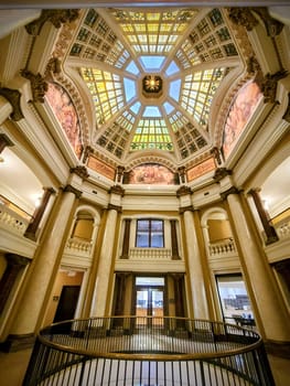 2022 Neoclassical Bloomington Courthouse in Indiana, showcasing a luxurious interior with a striking stained glass ceiling and grand Corinthian columns