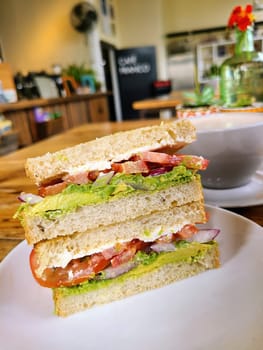 Fresh BLT sandwich in cozy San Francisco cafe, capturing a casual dining experience in 2023