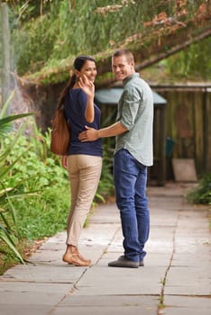 Couple, waving and love or portrait in garden, relationship and care on outdoor adventure or holiday. People, marriage and walking on vacation and romance in park or zoo, date and calm or peace.