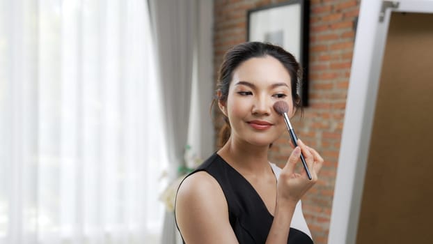 Woman influencer shoot live streaming vlog video review vivancy makeup social media or blog. Happy young girl with cosmetics studio lighting for marketing recording session broadcasting online.