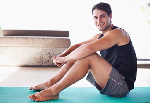 Yoga, mat and portrait of happy man on a living room floor for balance, routine or mental health wellness. Spirituality, profile and male person in a house with peace, zen or holistic stress relief.