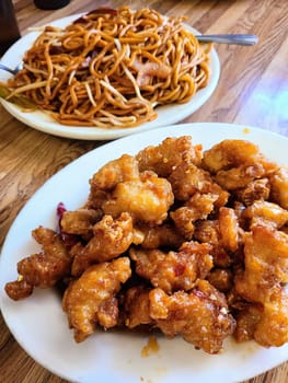 General Tso's Chicken and Lo Mein served in a San Francisco restaurant, highlighting the vibrant flavors of Chinese cuisine, 2023