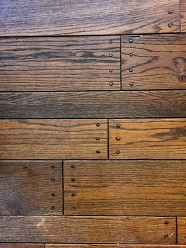 Close-up of a textured wooden surface with varying hues, showcasing traditional craftsmanship. Ideal for design and architecture, 2021, Indiana.