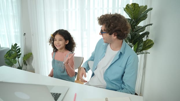 Caucasian father put on pencil on ear while daughter looking at dad and put pencil on ear. Smart dad writing engineering code and generated AI by using laptop. Family spend time together. Pedagogy.