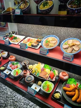 Vibrant display of Japanese cuisine featuring sushi platter, steaming ramen bowls, and Izakaya Special set meal in a San Francisco restaurant, 2023