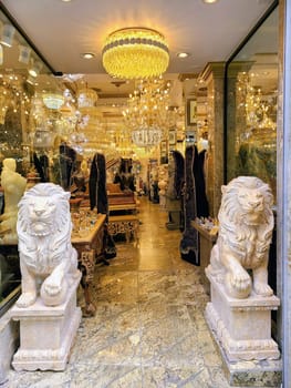 Luxurious boutique interior in San Francisco, 2023, featuring white lion statues, glittering chandeliers, and ornate decor items