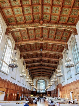 Grand Interior of University of Michigan's Historic Law Library, Illuminated by Natural Light and Stained Glass Window