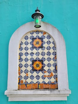 Vibrant Tiled Niche and Classic Lantern on a Colorful Wall in Mount Vernon, Ohio - Cultural Heritage and Architectural Beauty