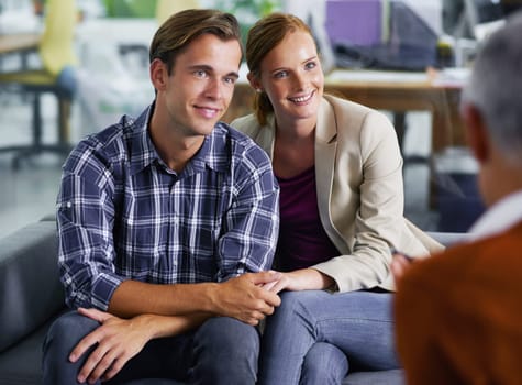 Marriage, therapy and couple happy with counselling in communication with partner, together and couch. Consulting, man and woman holding hands, conversation and psychologist in office for advice.